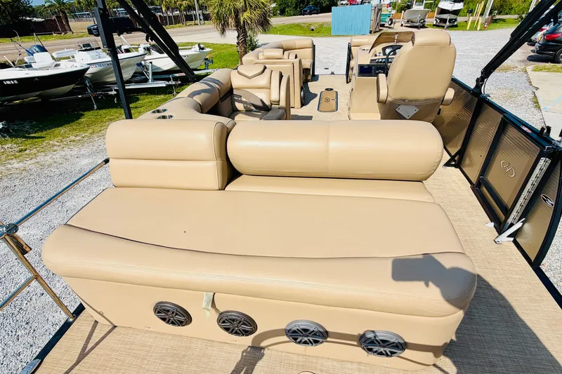 Slide: The Image of 2019 Harris Sunliner 230 pontoon boat with beige seating and spacious deck layout. - 21