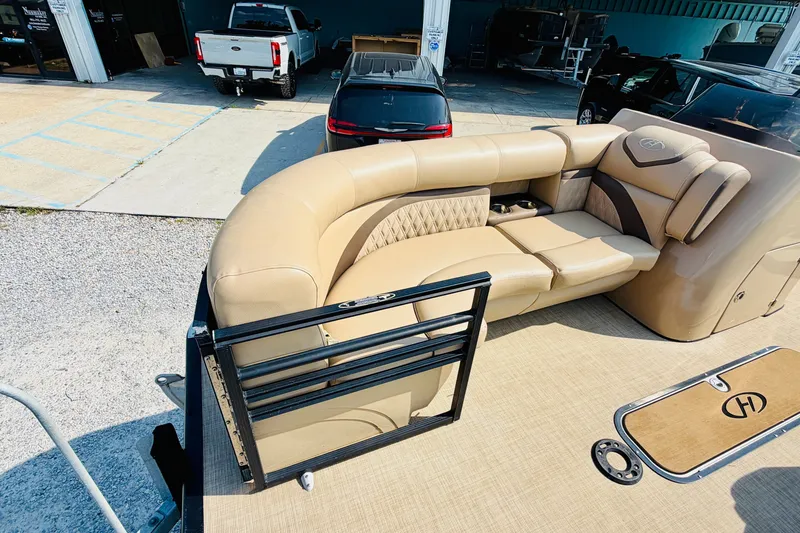 Slide: The Image of 2019 Harris Sunliner 230 pontoon boat with beige seating and elegant design. - 10