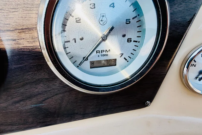 Slide: The Image of Close-up of 2019 Harris Sunliner 230 RPM gauge displaying 710.3 hours. - 19