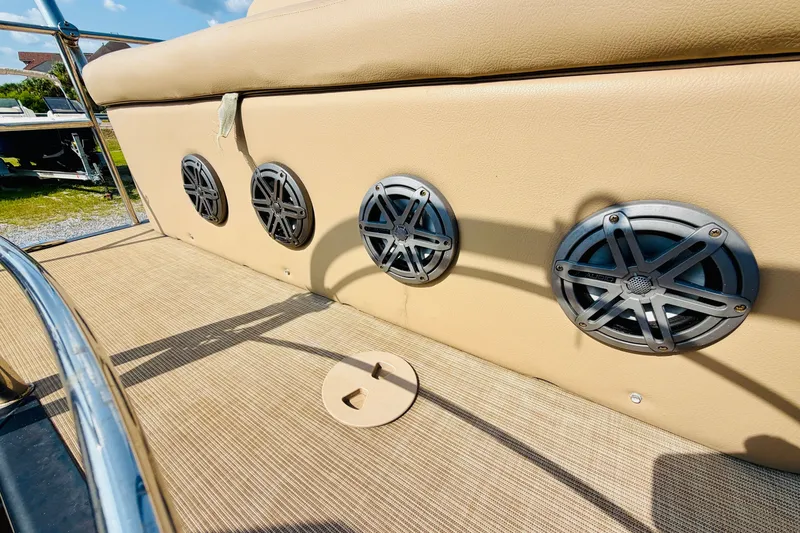 Slide: The Image of 2019 Harris Sunliner 230 boat speakers on beige upholstery, sunny day. - 26