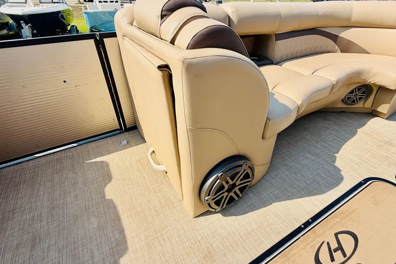 Slide: The Image of Luxurious interior of 2019 Harris Sunliner 230 pontoon boat with beige seating and speaker system. - 14