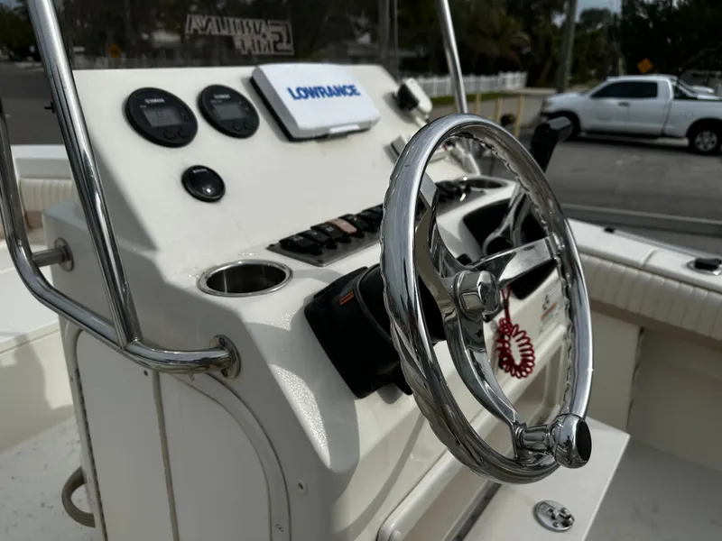 Slide: The Image of The image shows the helm of a 2016 Sea Chaser 20 HFC boat with a steering wheel and instruments. - 42