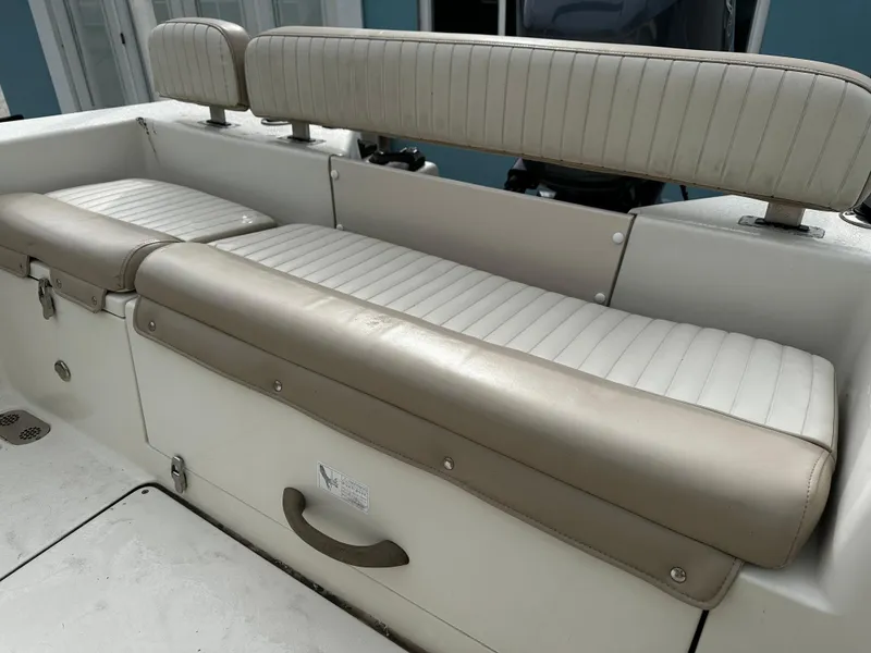 Slide: The Image of The 2016 Sea Chaser 20 HFC features a cushioned bench seat with cream and white upholstery. - 22