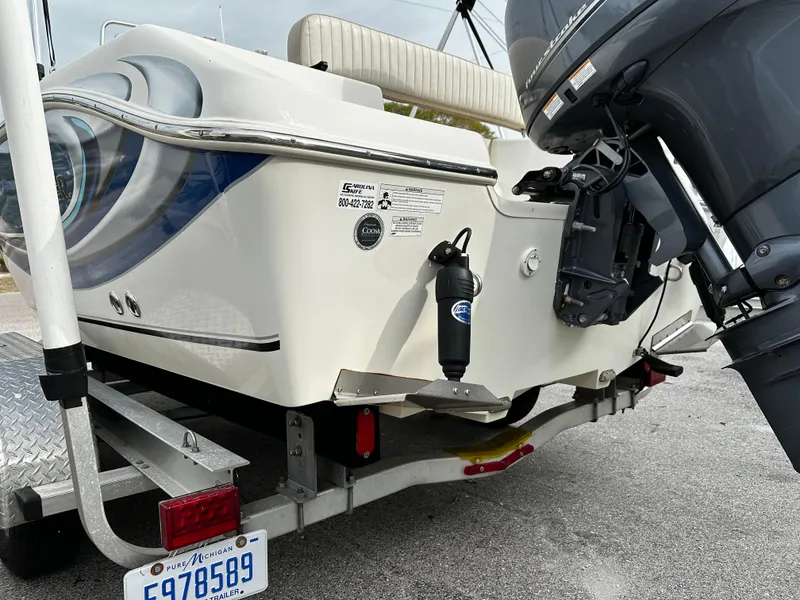 Slide: The Image of The image shows the rear of a 2016 Sea Chaser 20 HFC boat on a trailer. An outboard motor is visible. - 8