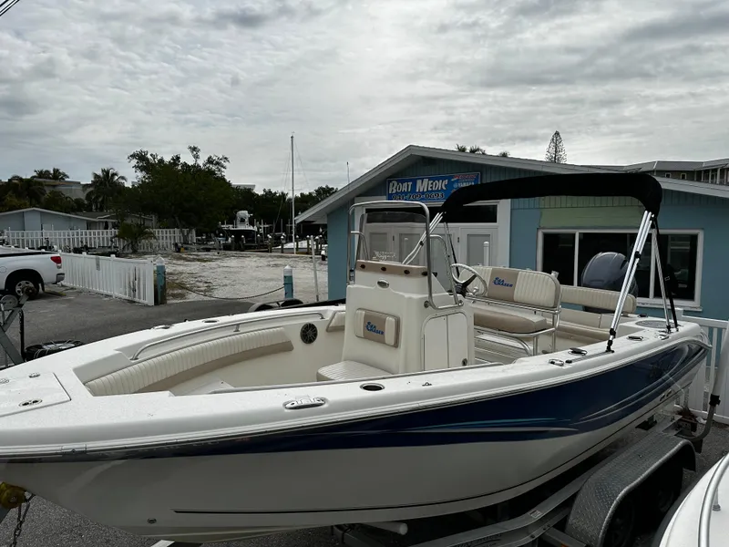Slide: The Image of A 2016 Sea Chaser 20 HFC boat on a trailer in front of a blue building. - 16