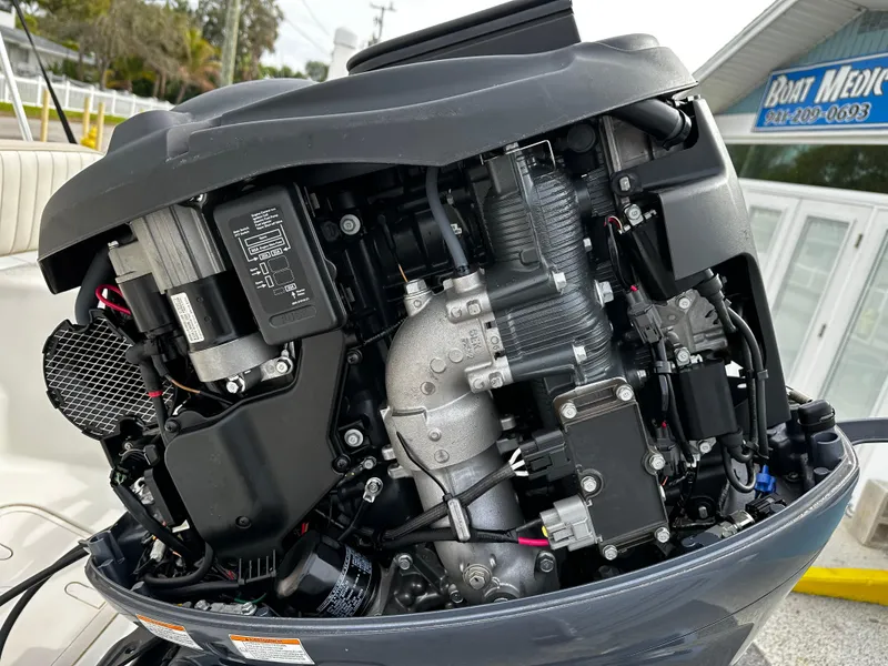 Slide: The Image of An open outboard motor of a boat reveals its internal mechanical components. - 19