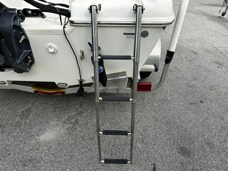 Slide: The Image of A retractable swim ladder is attached to the stern of a boat on a trailer. - 13