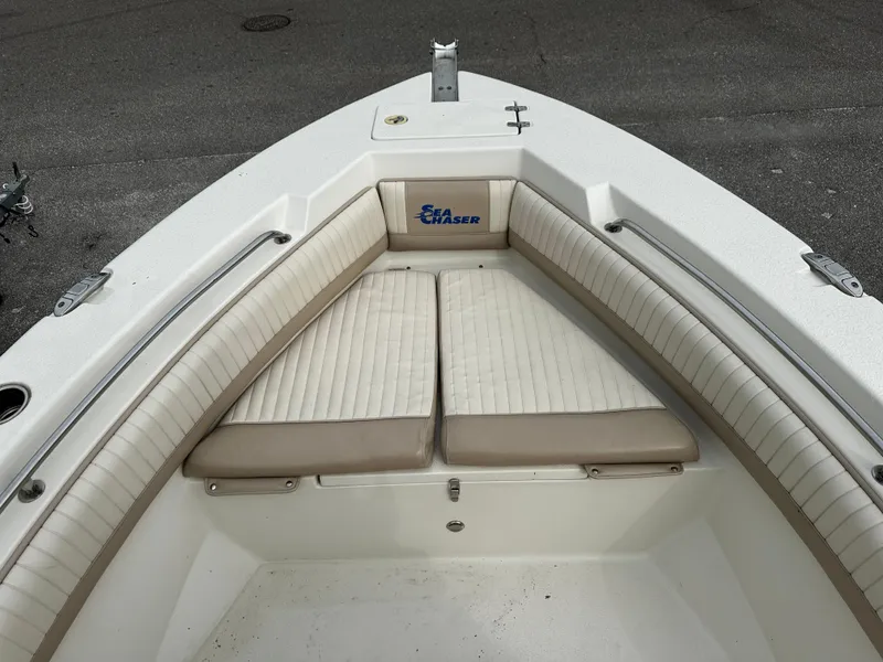 Slide: The Image of The image shows the bow of a Sea Chaser 20 HFC boat with cushioned seating. - 49