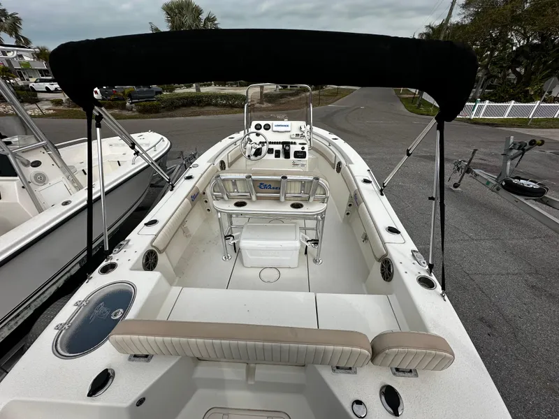 Slide: The Image of A 2016 Sea Chaser 20 HFC with a black bimini top and spacious cockpit. - 18