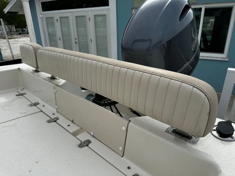 Slide: The Image of The image shows the rear bench seat of a 2016 Sea Chaser 20 HFC boat with an outboard motor. - 30