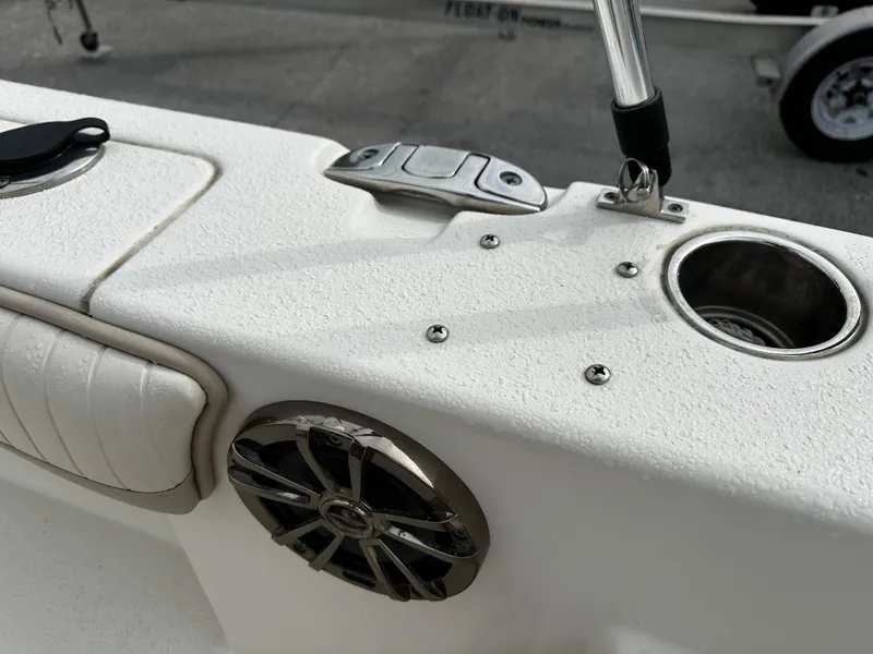 Slide: The Image of Close-up of a boat deck with a speaker and cup holder. - 32
