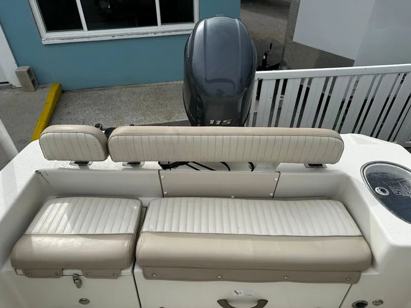 Slide: The Image of The image shows the rear seating of a 2016 Sea Chaser 20 HFC boat with an outboard motor. - 21