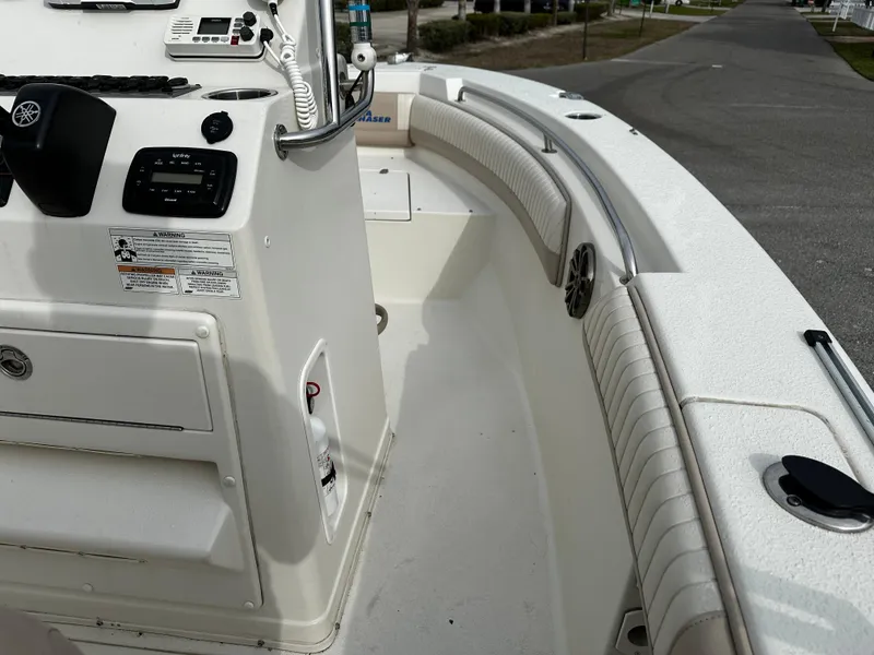 Slide: The Image of The image shows the deck of a 2016 Sea Chaser 20 HFC boat with a helm console. - 47