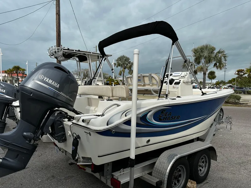 Slide: The Image of A 2016 Sea Chaser 20 HFC on a trailer, featuring a Yamaha outboard motor and a Bimini top. - 3