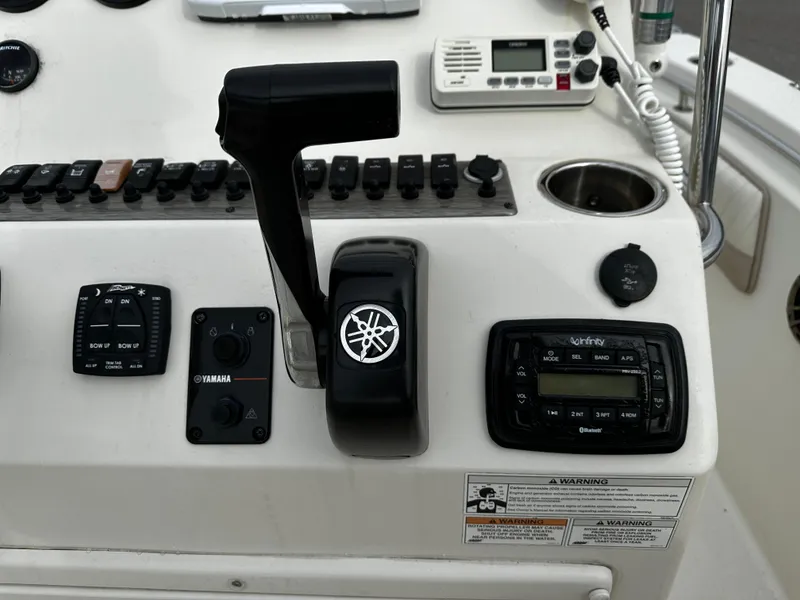 Slide: The Image of The image shows the helm of a Sea Chaser 20 HFC boat with various controls. - 44