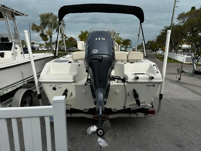 Slide: The Image of A 2016 Sea Chaser 20 HFC boat with a 115 HP outboard motor, parked in a lot. - 5