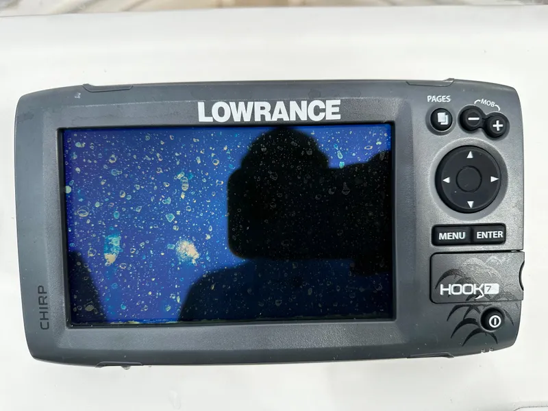 Slide: The Image of A Lowrance HOOK-7 fish finder with a wet screen, surrounded by controls. - 39
