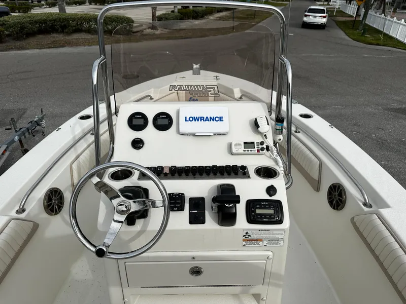 Slide: The Image of The image shows the helm of a 2016 Sea Chaser 20 HFC boat with various instruments. - 38
