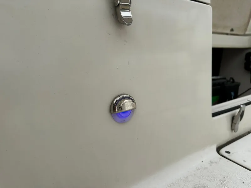 Slide: The Image of Close-up of a blue light on a white boat, likely a 2016 Sea Chaser 20 HFC. - 26