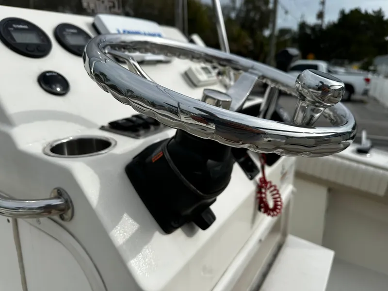 Slide: The Image of Close-up of a 2016 Sea Chaser 20 HFC helm with a shiny steering wheel and instruments. - 43