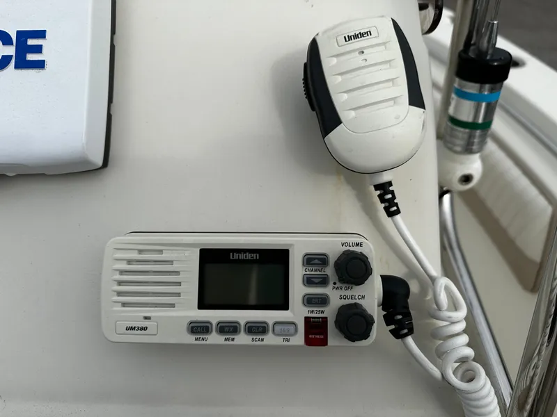 Slide: The Image of A Uniden radio with a microphone is mounted on a boat. - 45