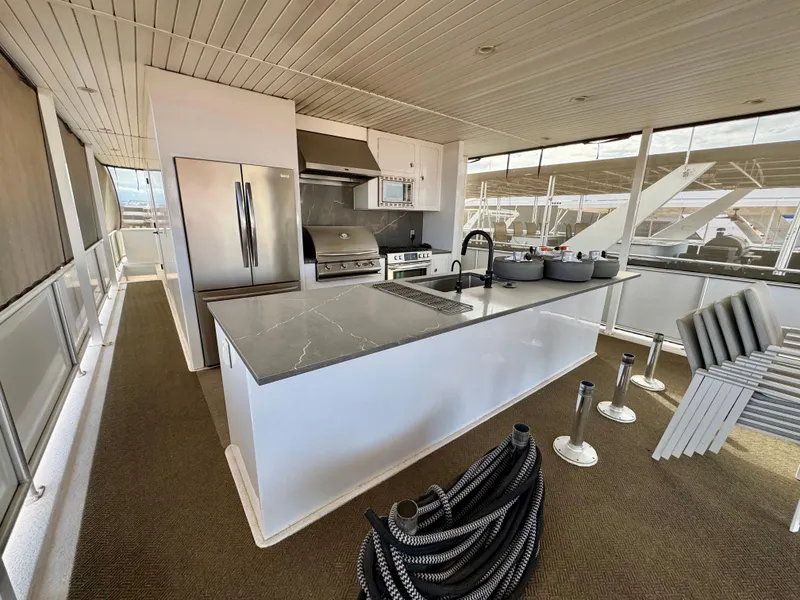 Slide: The Image of Modern kitchen on Adonia Solace Trip #16 houseboat, featuring stainless steel appliances and sleek countertops. - 22