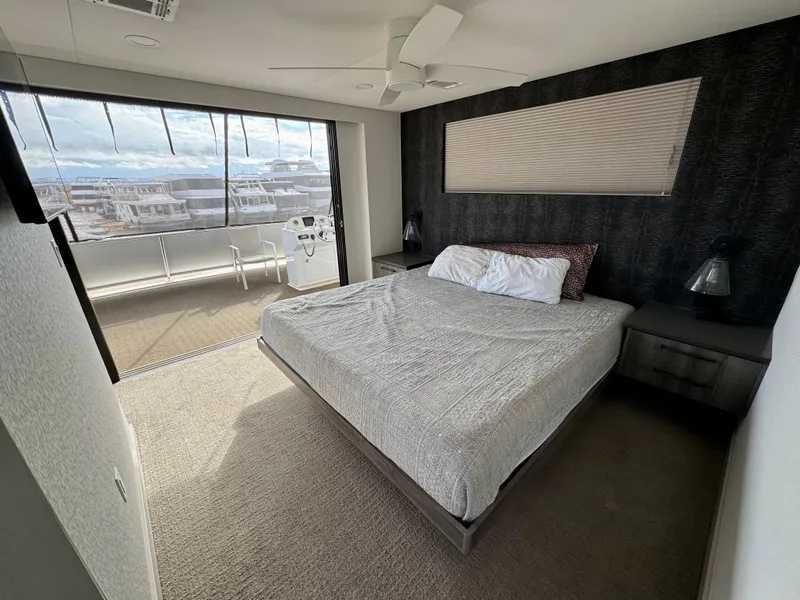 Slide: The Image of Modern bedroom in Adonia Solace Trip #16 houseboat, featuring a large bed and scenic window view. - 20