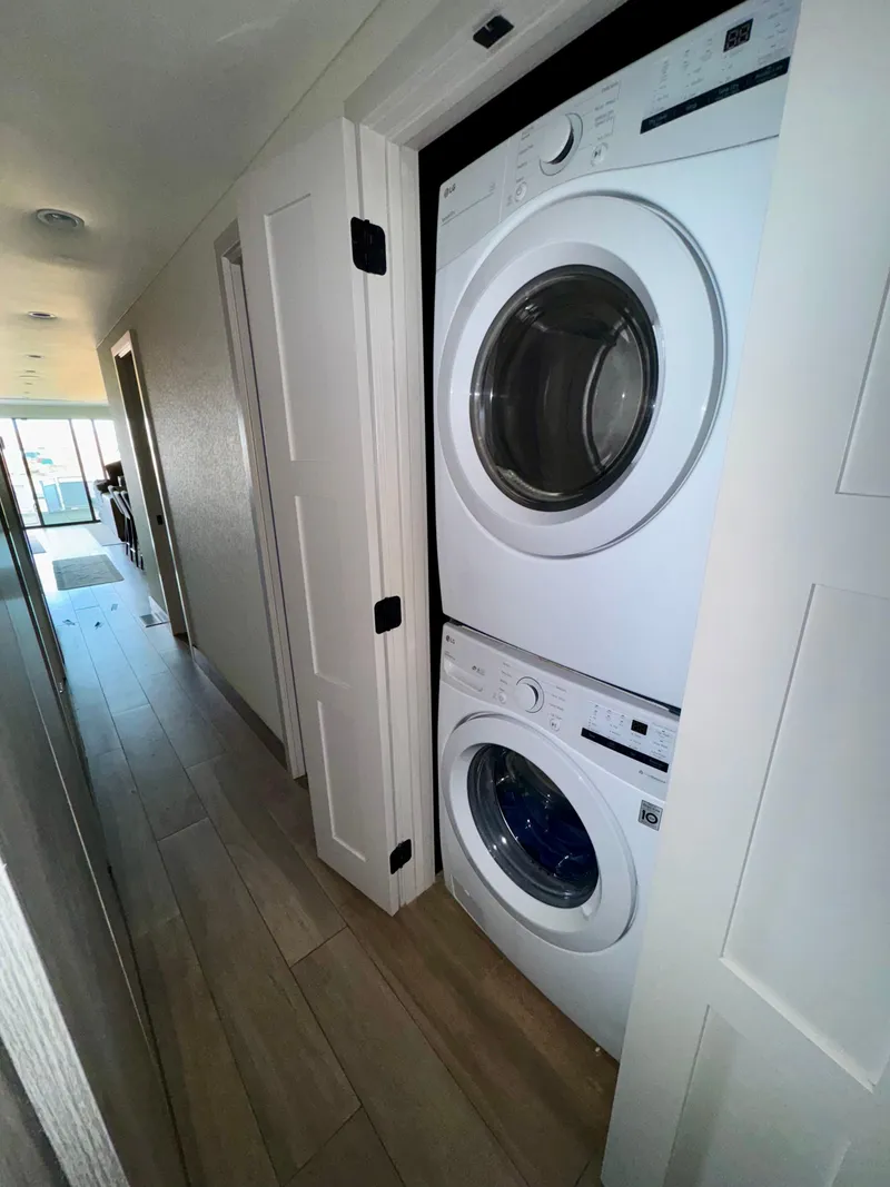 Slide: The Image of Stacked washer and dryer in hallway of Adonia Solace Trip #16, 2021 model. - 9
