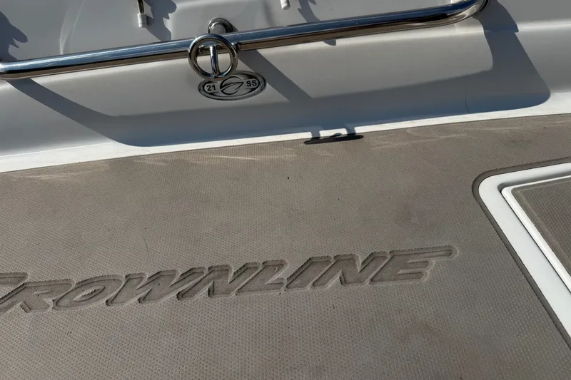Slide: The Image of 2013 Crownline 21 SS boat deck with logo and stainless steel railing. - 19