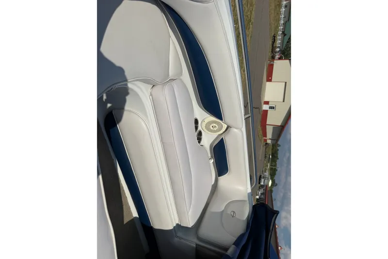 Slide: The Image of Interior of a 2013 Crownline 21 SS boat, featuring white and blue seating. - 15