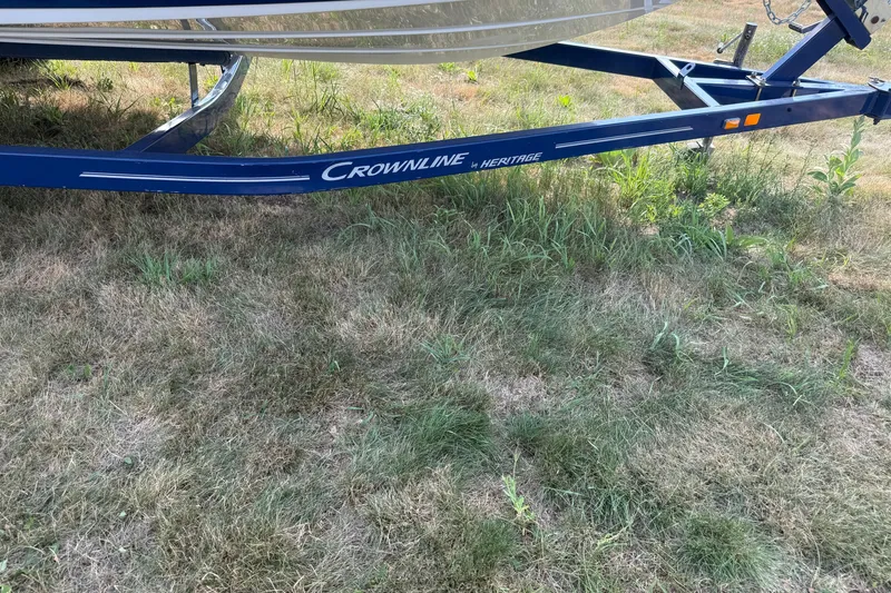 Slide: The Image of Trailer for 2013 Crownline 21 SS boat on grassy ground. - 10
