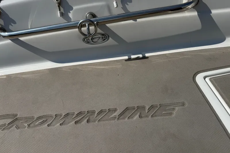 Slide: The Image of 2013 Crownline 21 SS boat deck with logo and stainless steel railing. - 18