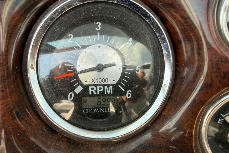 Slide: The Image of Close-up of 2013 Crownline 21 SS RPM gauge displaying 699.9 hours. - 22