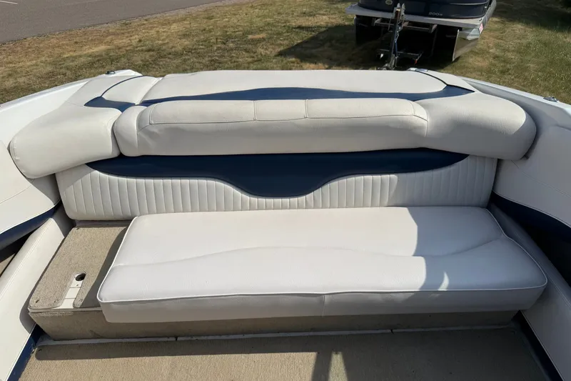Slide: The Image of 2013 Crownline 21 SS boat interior seating with white and blue upholstery. - 24