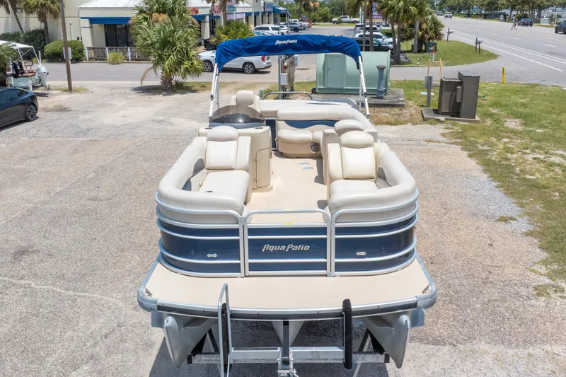 Slide: The Image of 2014 Aqua Patio 22 SLC pontoon boat with blue canopy, parked on a lot. - 5