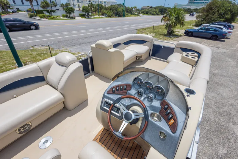 Slide: The Image of 2014 Aqua Patio 22 SLC pontoon boat with spacious seating and modern dashboard controls. - 22