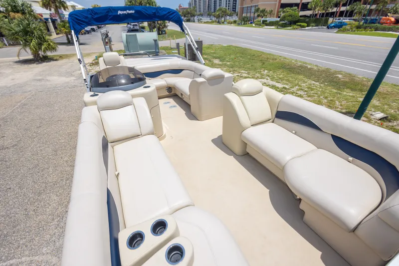 Slide: The Image of 2014 Aqua Patio 22 SLC pontoon boat with spacious seating and cup holders, parked roadside. - 26