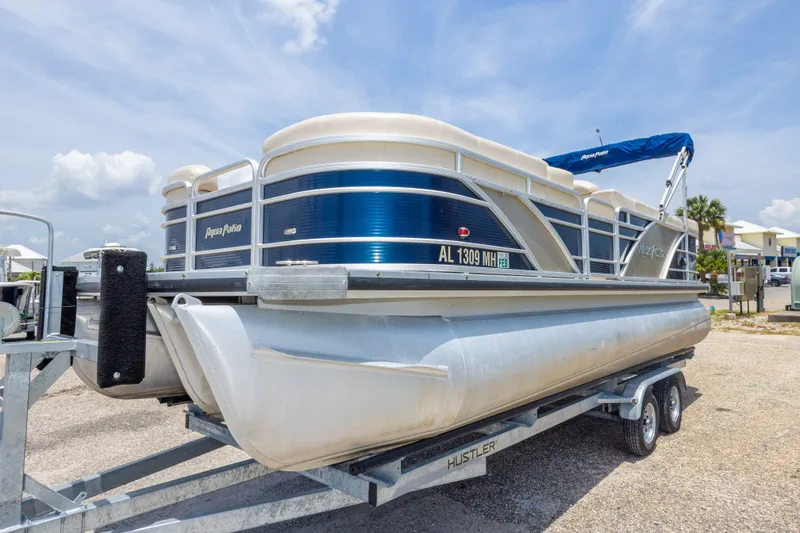 Slide: The Image of 2014 Aqua Patio 22 SLC pontoon boat on trailer under a clear sky. - 15