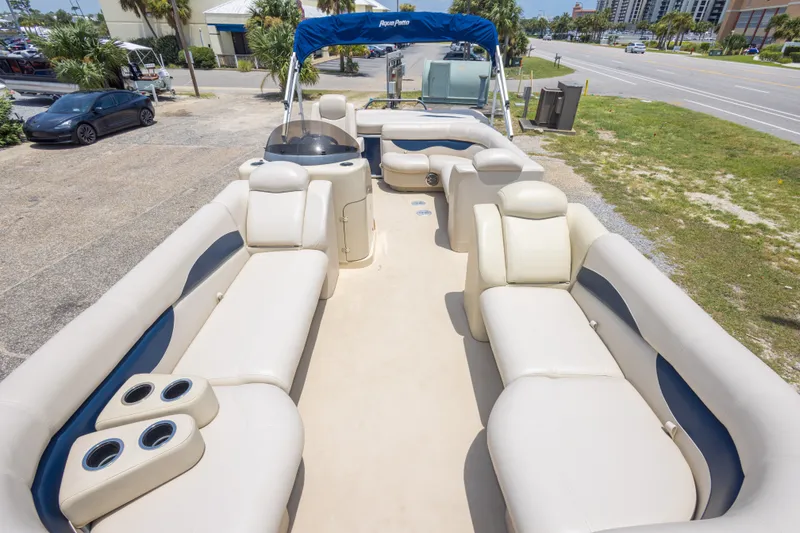Slide: The Image of 2014 Aqua Patio 22 SLC pontoon boat with spacious seating and canopy, parked near a road. - 27