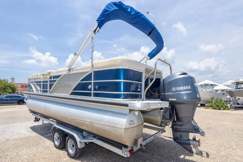 Slide: The Image of 2014 Aqua Patio 22 SLC pontoon boat with Yamaha motor on trailer, under clear sky. - 13