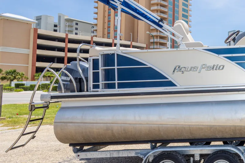 Slide: The Image of 2014 Aqua Patio 22 SLC pontoon boat on trailer, urban background. - 33