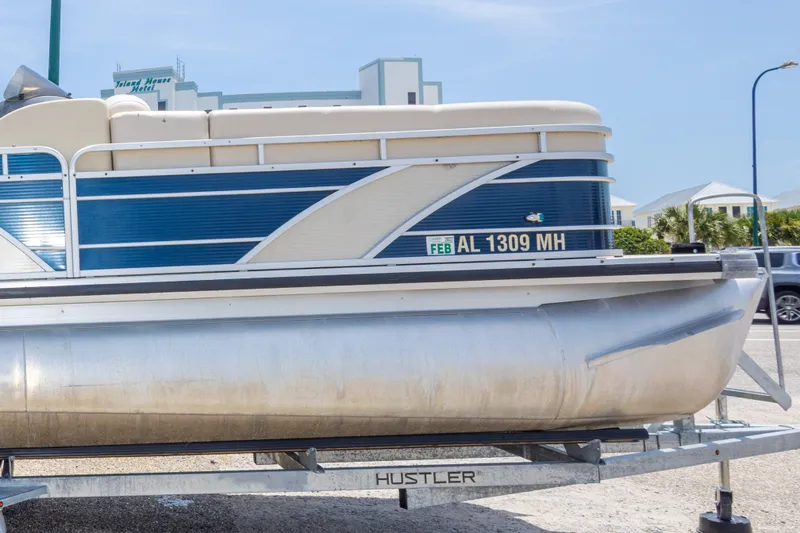 Slide: The Image of 2014 Aqua Patio 22 SLC pontoon boat on trailer, parked outdoors. - 34
