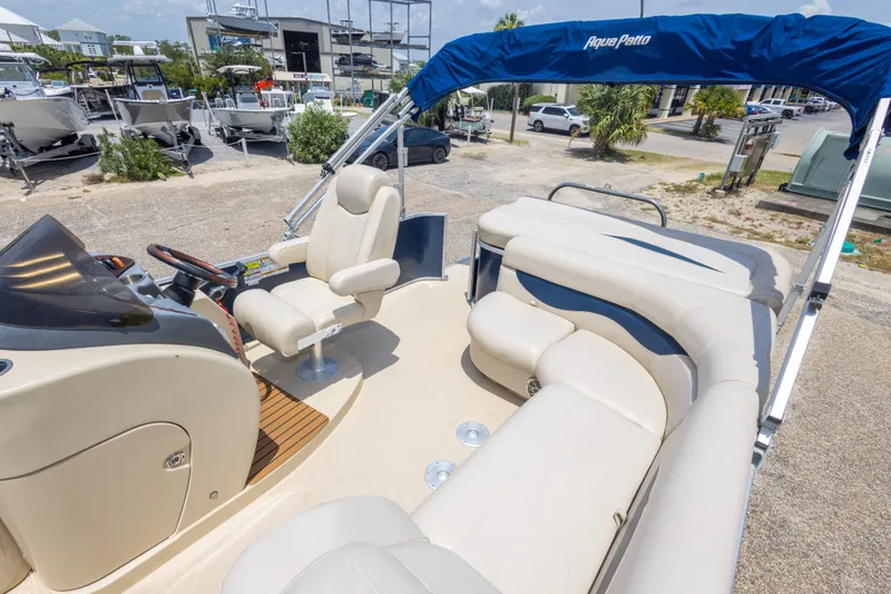 Slide: The Image of 2014 Aqua Patio 22 SLC pontoon boat with beige seating and blue canopy. - 29