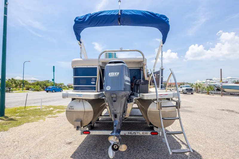 Slide: The Image of 2014 Aqua Patio 22 SLC pontoon boat with Yamaha 150 engine, parked on a sunny day. - 12