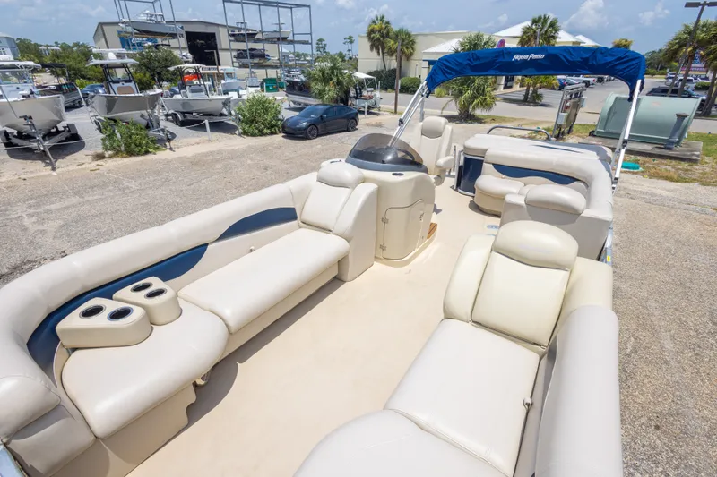 Slide: The Image of 2014 Aqua Patio 22 SLC pontoon boat with spacious seating and canopy in a marina setting. - 25