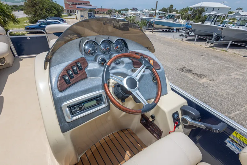 Slide: The Image of Steering console of 2014 Aqua Patio 22 SLC boat with gauges and controls. - 21