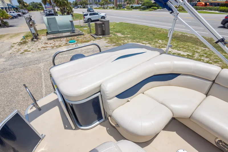 Slide: The Image of 2014 Aqua Patio 22 SLC pontoon boat with white seating, parked near a road. - 30