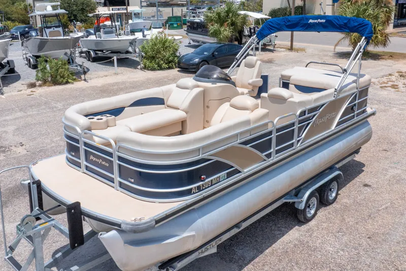 Slide: The Image of 2014 Aqua Patio 22 SLC pontoon boat on trailer, parked outdoors. - 4