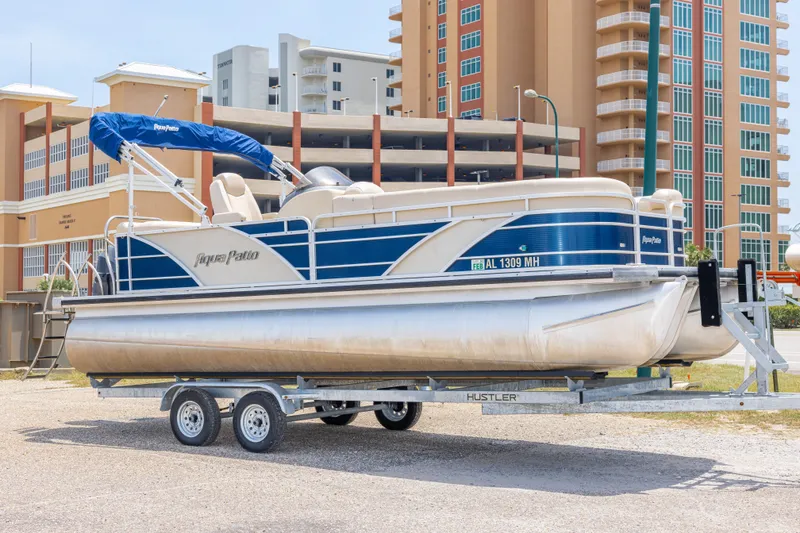 The Image of 2014 Aqua Patio 22 SLC pontoon boat on trailer, urban background. - 0