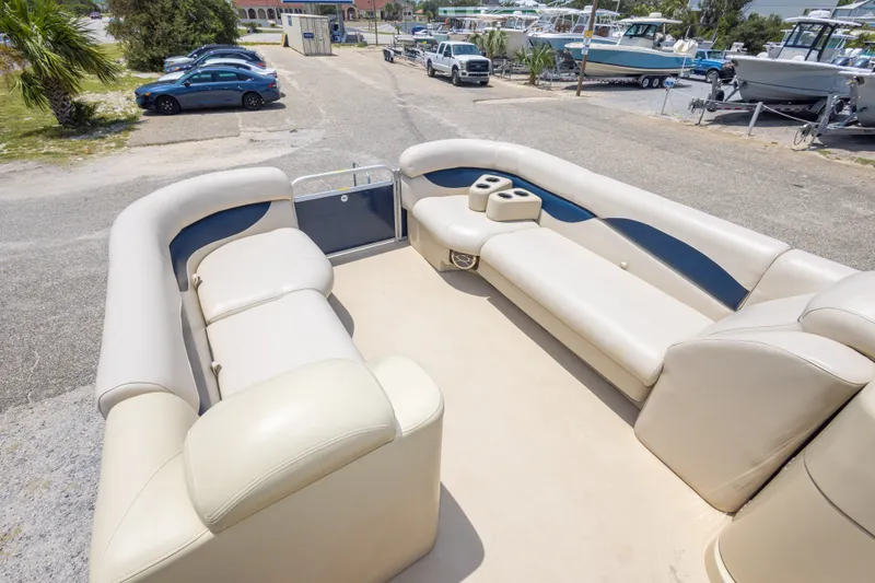 Slide: The Image of 2014 Aqua Patio 22 SLC pontoon boat with spacious seating and cup holders, parked outdoors. - 24